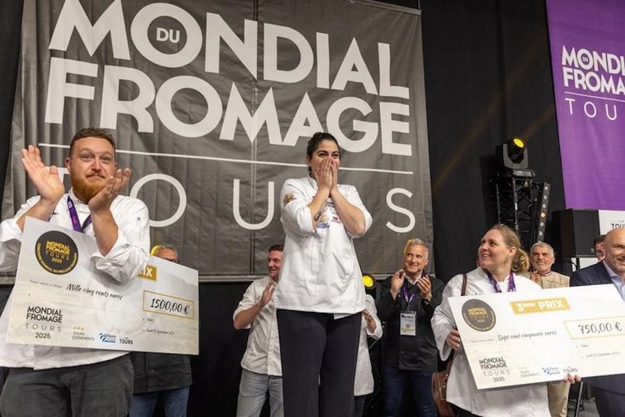 Emilia on the Mondial du Fromage stage with her hands over her mouth as the result is announced