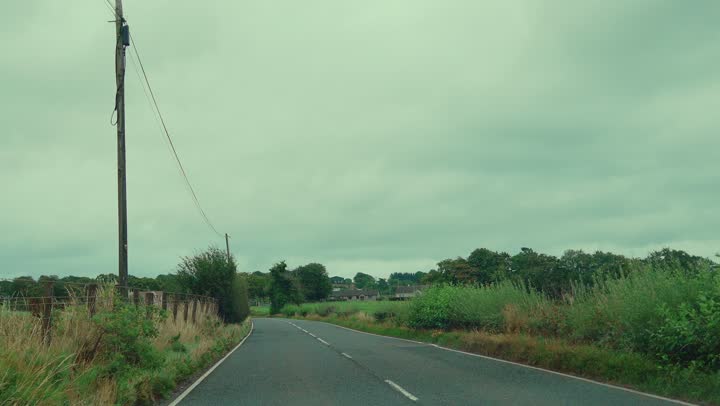 A two-lane country road under a wide sky